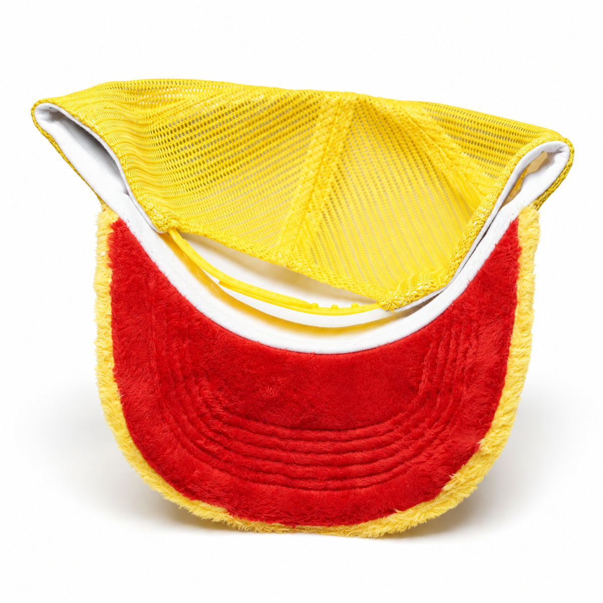 Underside of yellow LYFAH trucker hat showing the red plush underbrim, white inner band and yellow mesh.
